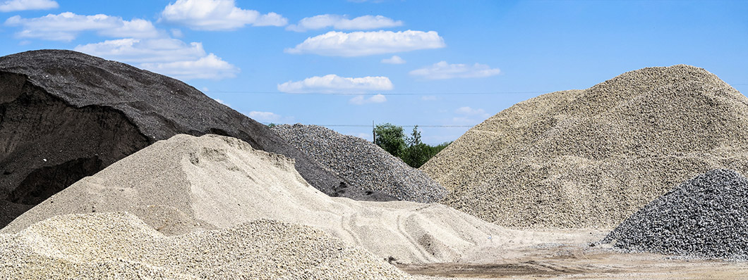 stock photo large hills and piles of sand gravel crushed stone of white gray and black color 2072893007
